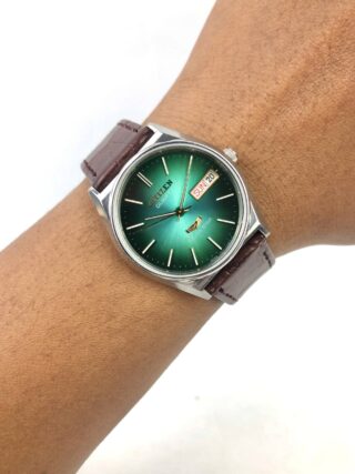 CITIZEN SEVEN STAR QUARTZ GREEN SUNBURST DIAL DAY-DATE MEN’S WATCH